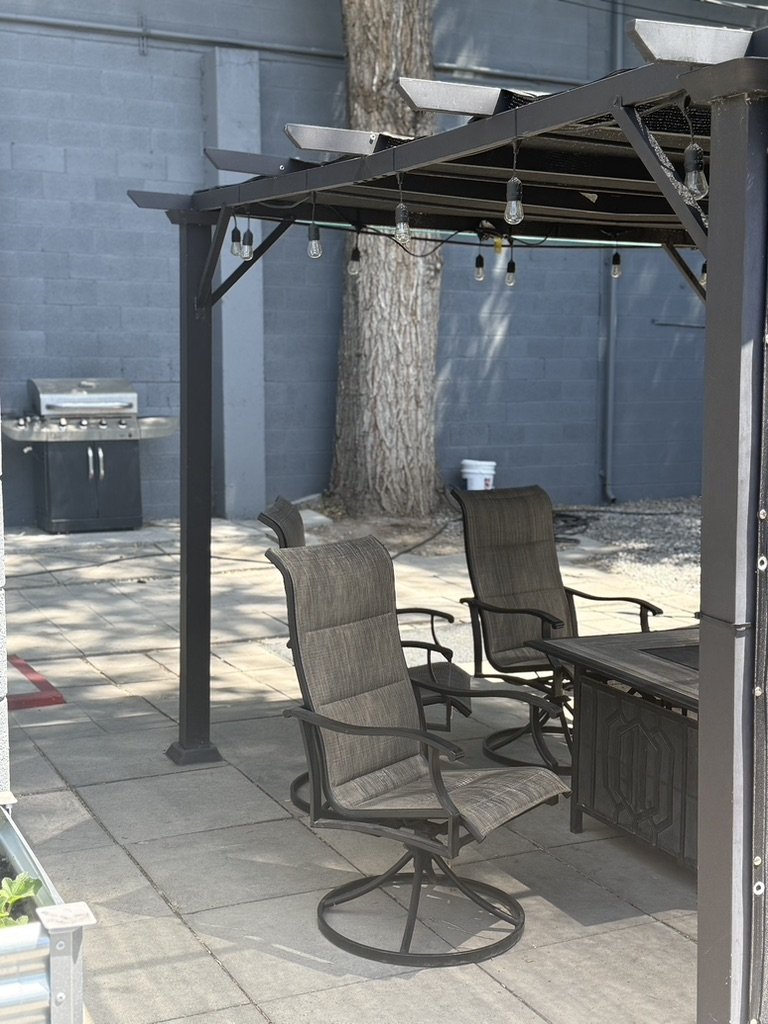 Outdoor patio with a grill and seating on the west side of the campus